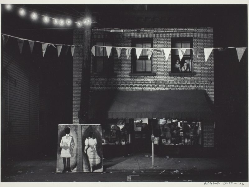 W. Eugene Smith, Untitled [night view, store front with pennants], 1955/56